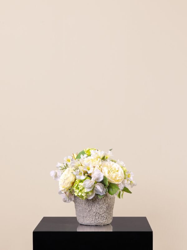 Zen Ivory Stone artificial white flower arrangement in a gray ceramic rock vase with white roses, cream hydrangeas, and viburnum.