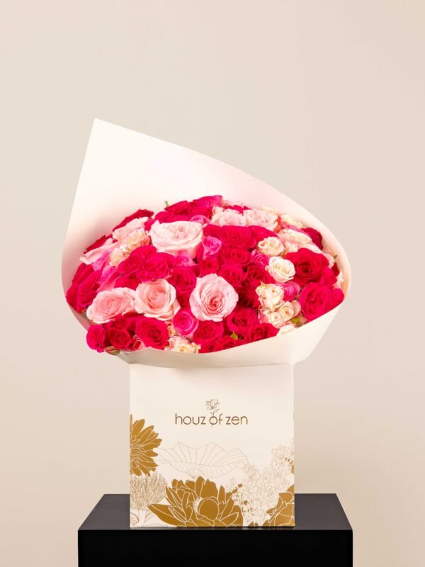 Fuchsia and blush rose bouquet wrapped in white paper from Houz of Zen