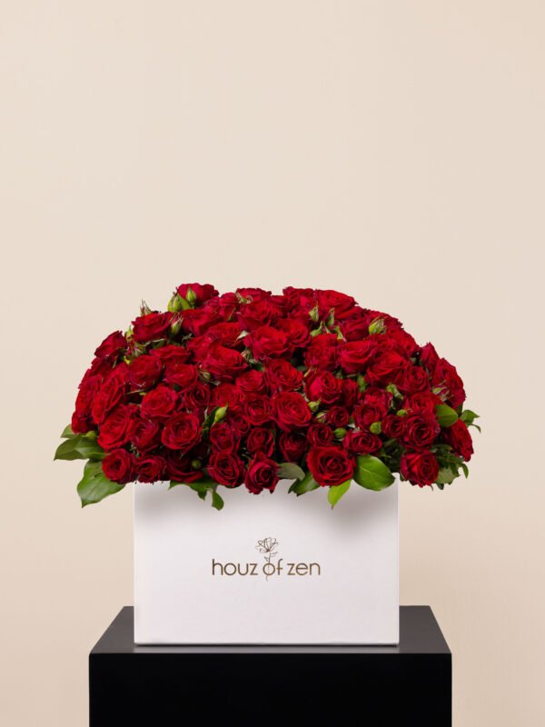 large flower box filled with red spray roses in dome shape