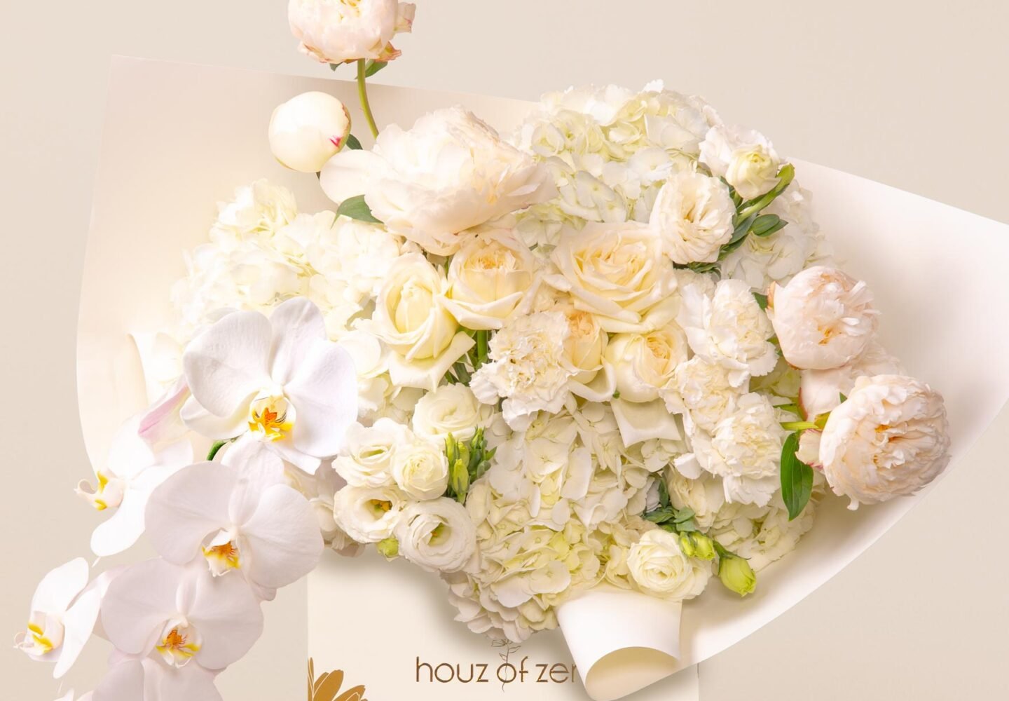 ivory white flower bouquet with peonies, orchids, hydrangeas, and lisianthus in white wrap