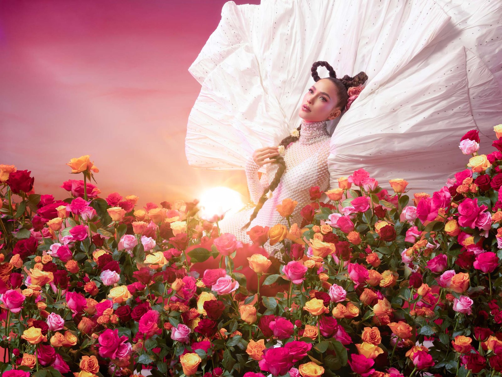 Arci Muñoz in a sculptural white couture gown surrounded by vibrant roses with sunset lighting, styled by Houz of Zen