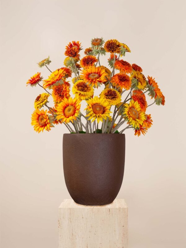 Artificial sunflower arrangement in Dubai with orange and yellow blooms in a brown vase.