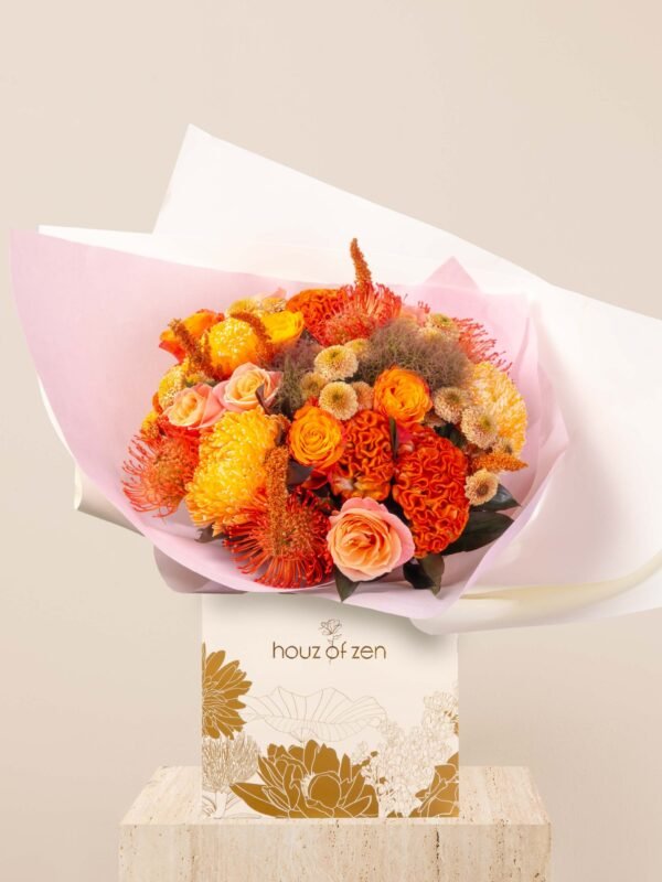 Orange flower bouquet with roses, celosia, and chrysanthemums in Houz of Zen signature wrap