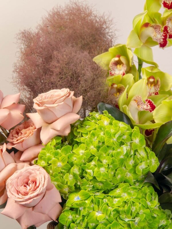 Green flower basket Dubai with cappuccino roses, cymbidium orchids, and emerald hydrangeas.