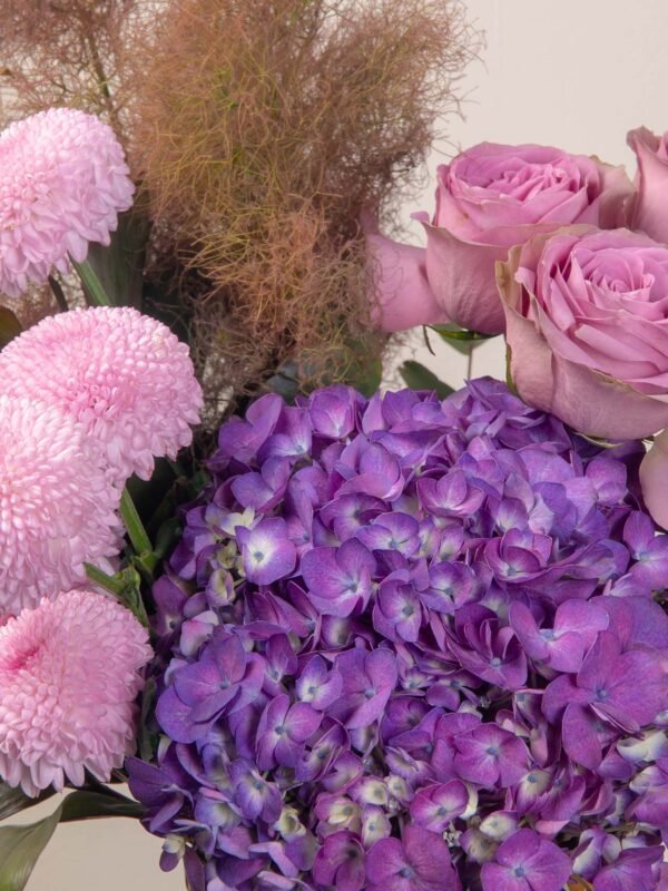 Close-up of luxury violet flower box with purple hydrangeas and pink chrysanthemum pingpong