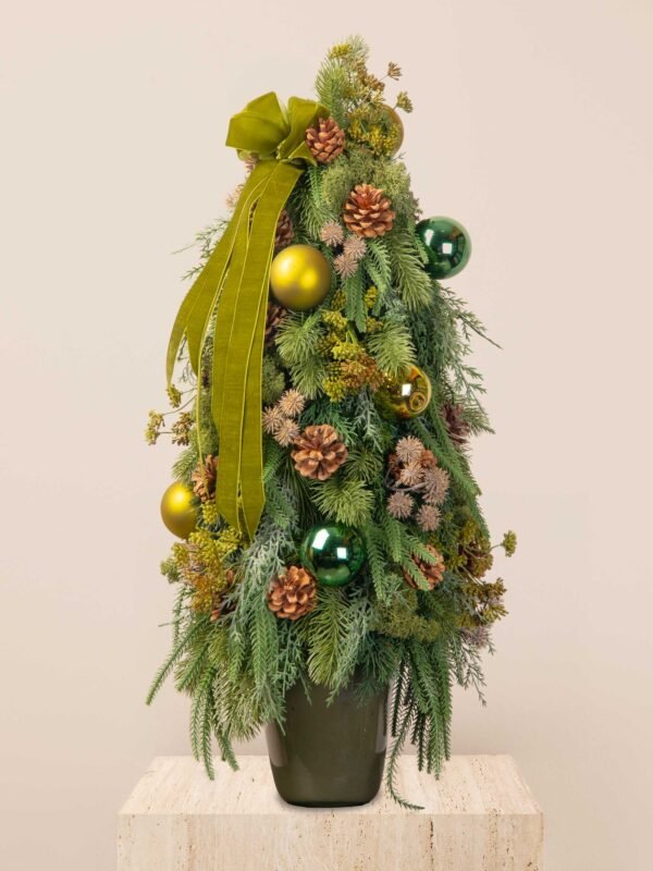 Evergreen faux mini tree with lifelike greenery, pinecones, emerald ornaments, and an olive velvet ribbon.