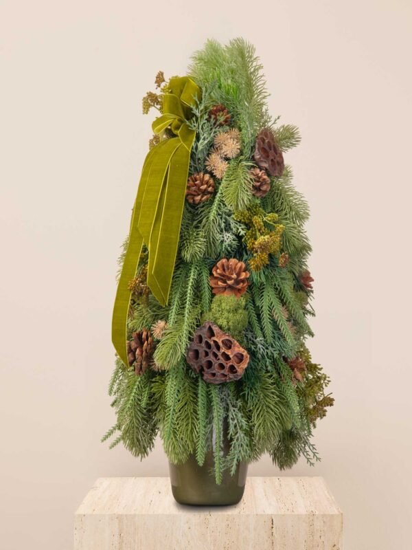 Forest faux mini tree with layered greenery, pinecones, lotus pods, moss accents, and an olive velvet ribbon.