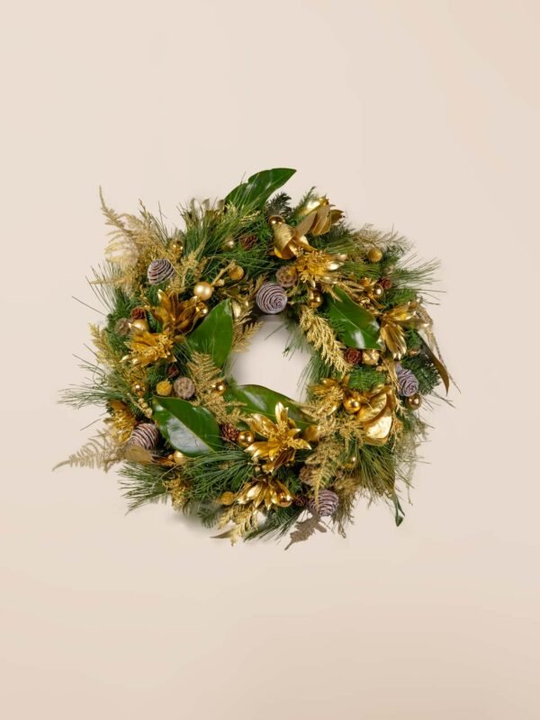 Fresh gold holiday wreath featuring fresh evergreens, magnolia leaves, gold botanicals, ornaments, and pinecones.
