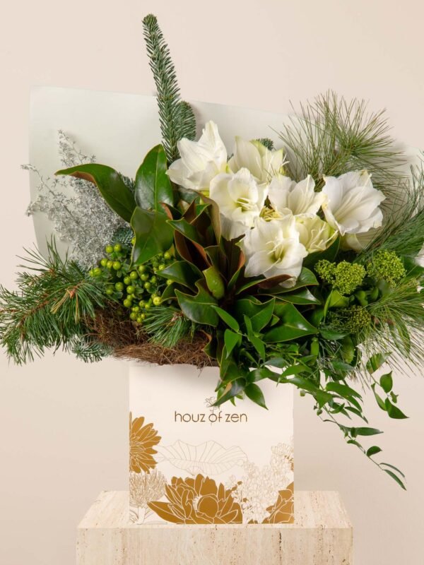 Fresh white festive flower bouquet with amaryllis, winter greens, magnolia leaves, and pine arranged in a Houz of Zen box.
