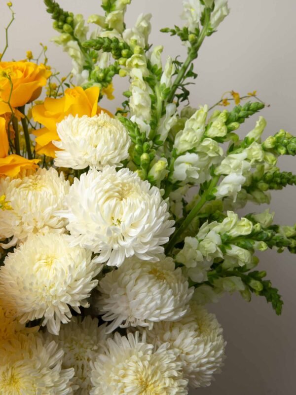 White chrysanthemums and snapdragons close-up from ZEN Sunlit Bloom flower box in Dubai